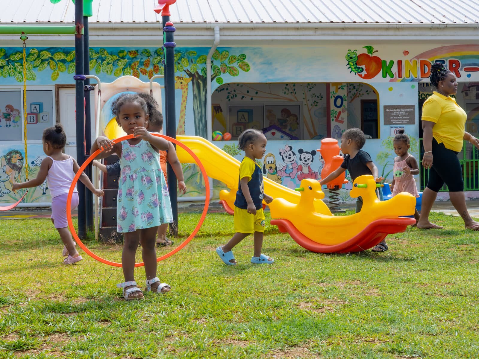 A wide view of children playing on the outdoor playground equipment